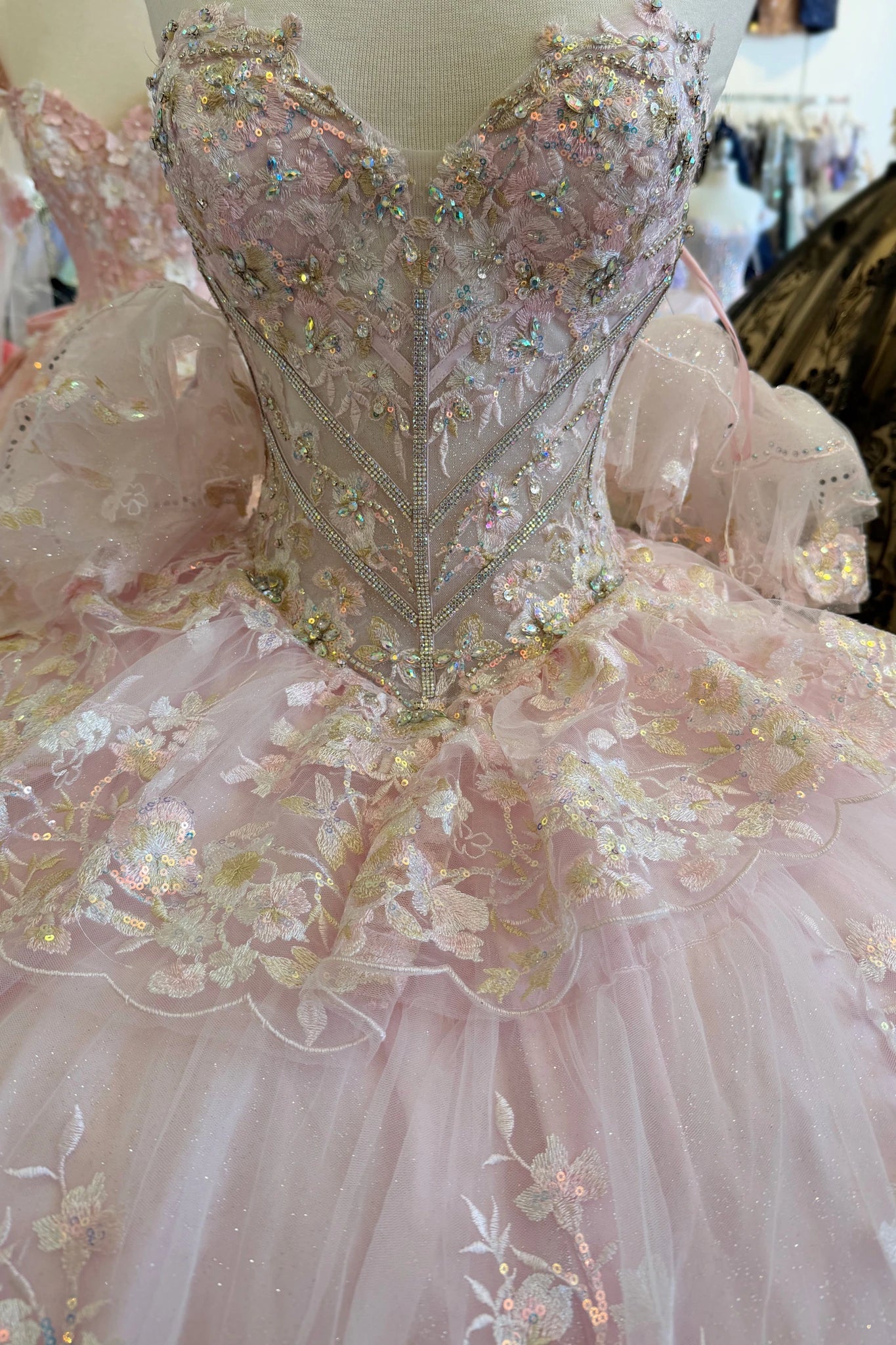 Close-up of a pink quince gown with intricate detailing and embellishments.