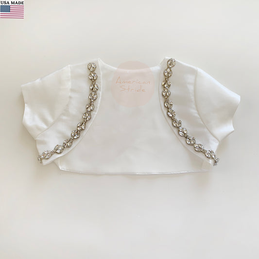 White bolero jacket with decorative rhinestone trim on a light background