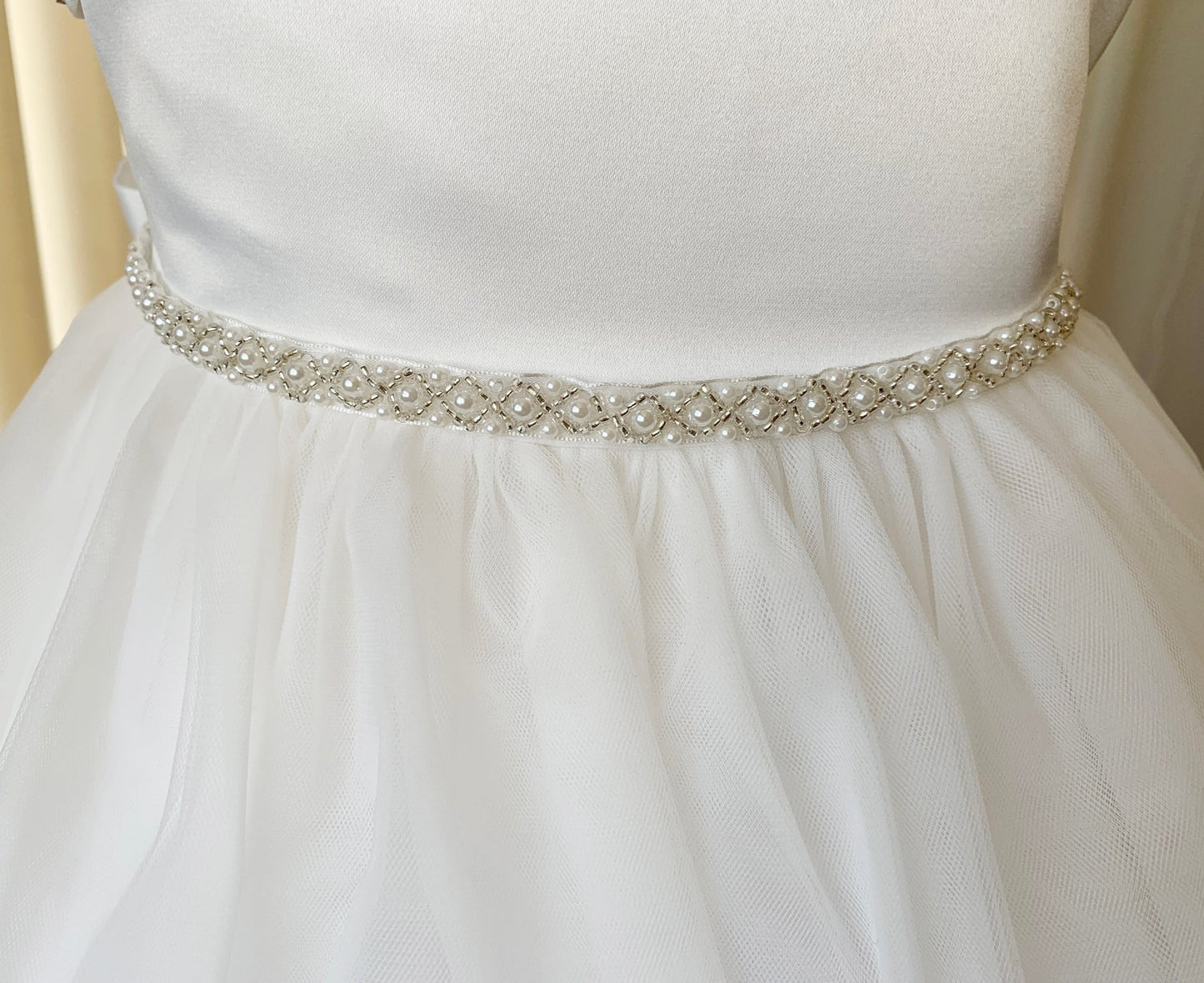 Off White dress with a decorative belt on a mannequin