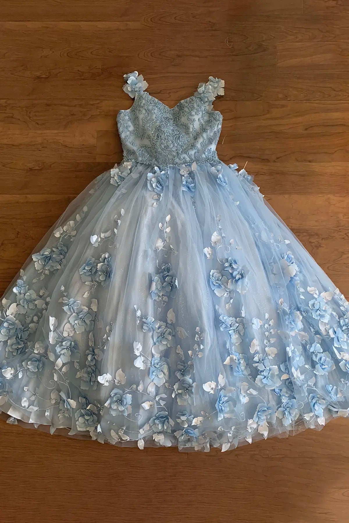 Light blue floral dress on a wooden floor