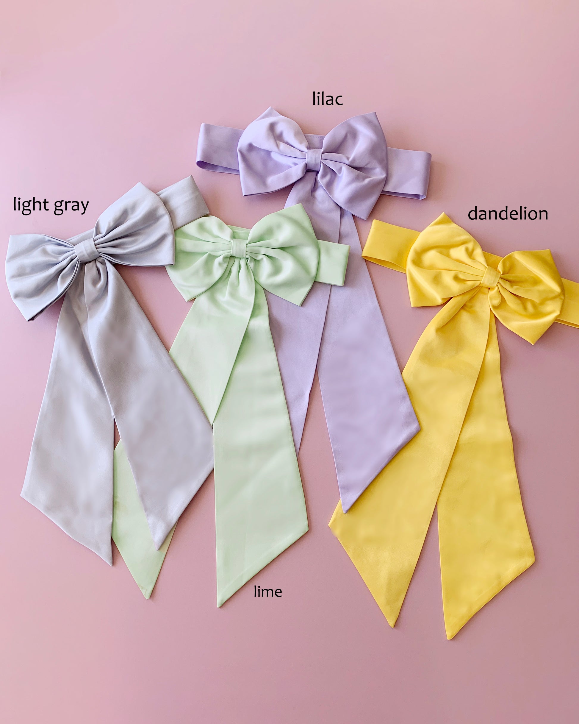 Four colorful bows labeled 'light gray', 'lilac', 'lime', and 'dandelion' on a pink background.