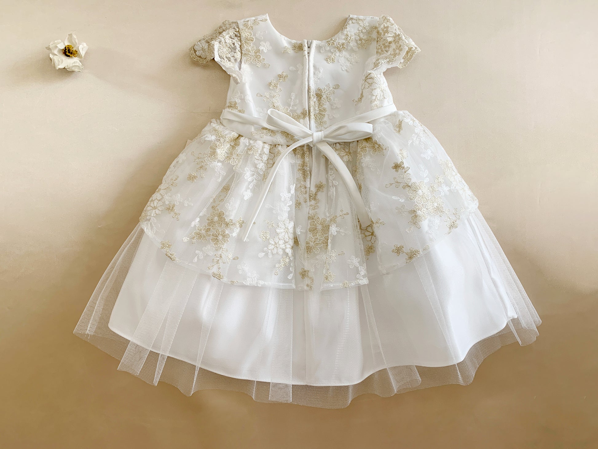 White floral dress with a belt on a beige background