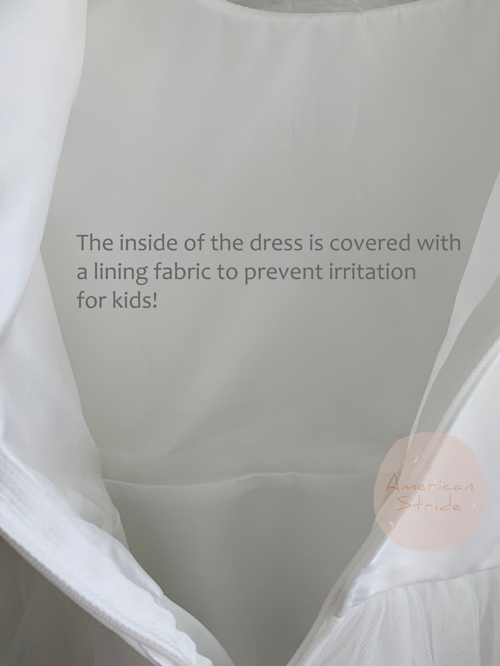 Close-up of a dress interior with lining fabric, featuring a brand logo.