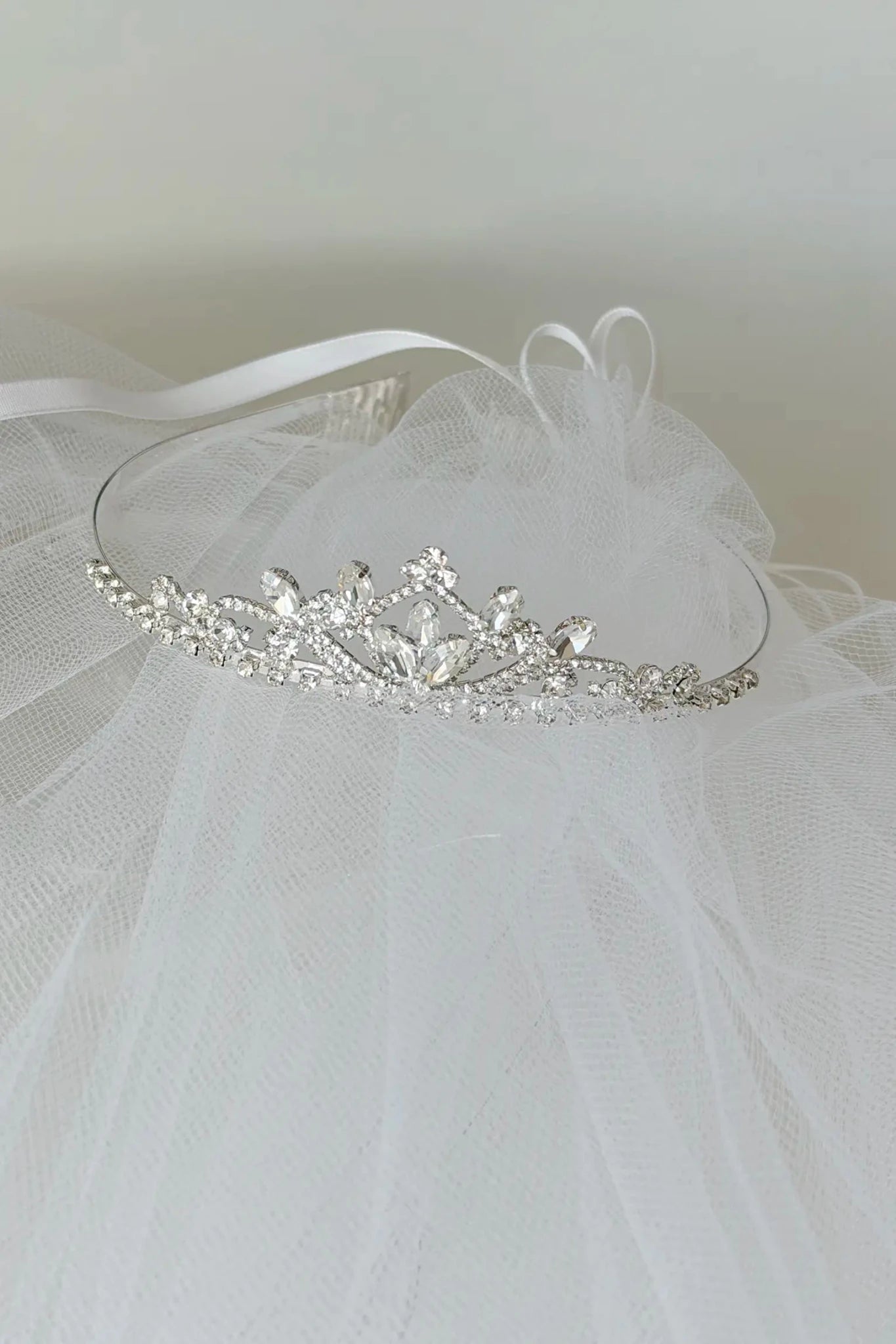 Silver tiara on a white veil against a light background