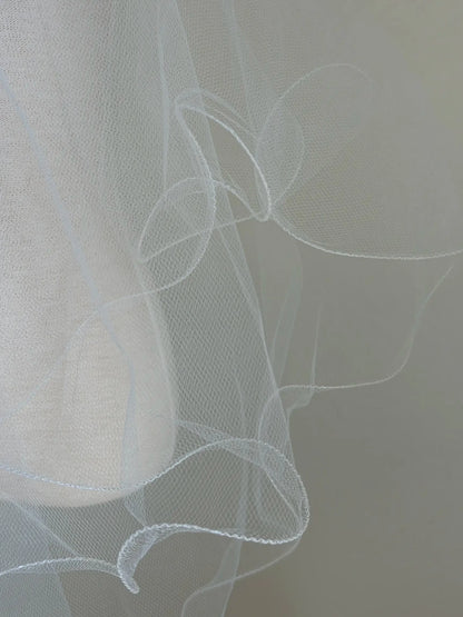 Close-up of a white veil with a blurred background