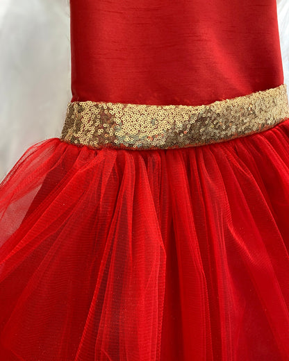 Red dress with a gold sequined waistband on a white background