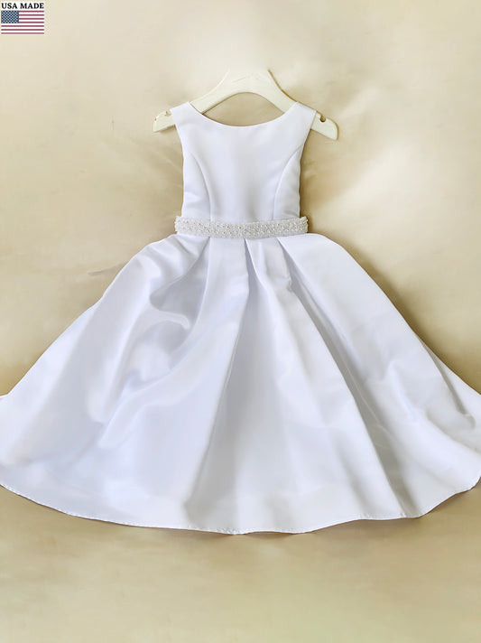 White dress with a pearl belt on a beige background