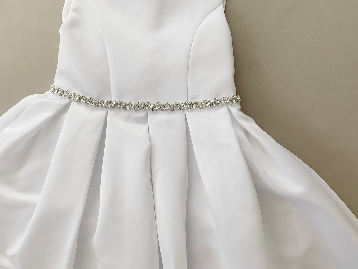 USA Made | Communion dress Fully Satin Dress with Rhinestone belt - zoomed in front view of dress showcasing belt detail