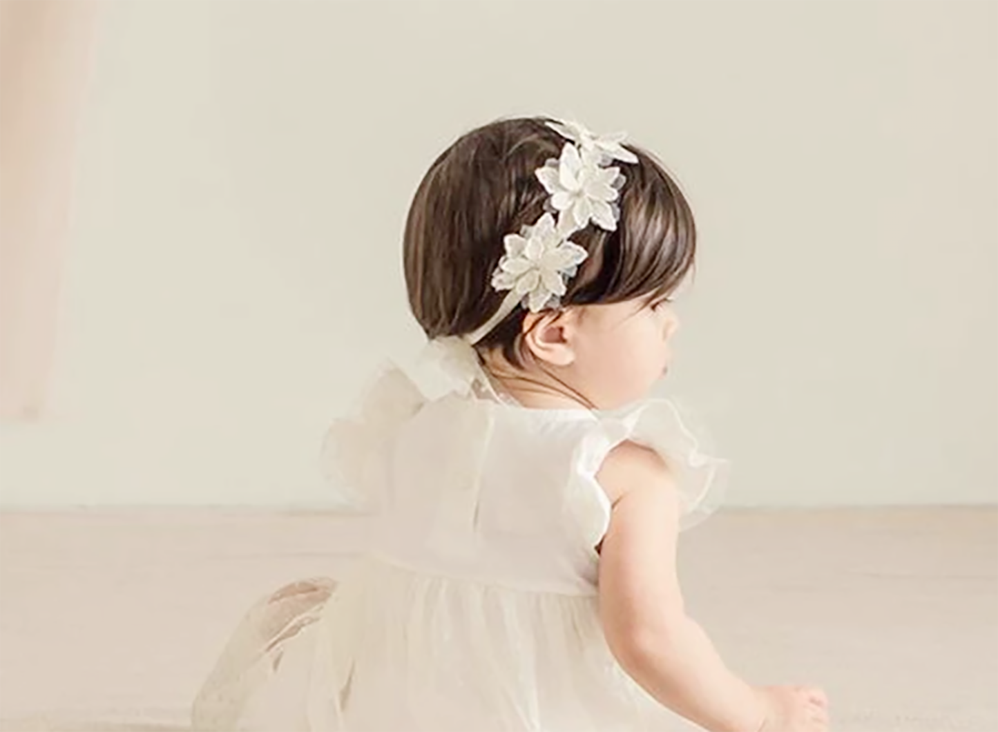 Handmade Baby Rhinestone Flower Off-white Headband - back view of toddler wearing headband on head