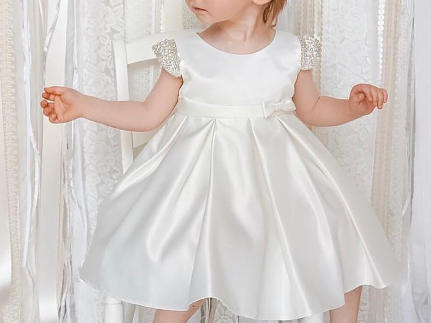 Ivory Flower Girl Beaded Short Sleeves Dull Satin dress with Detachable Pearl Sash - front view of girl wearing dress