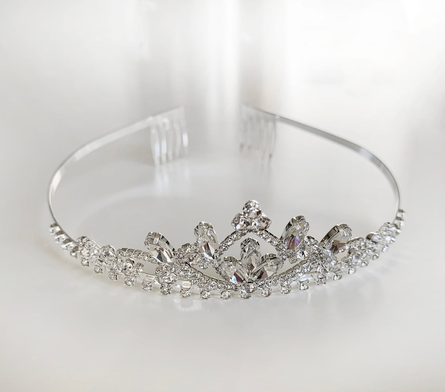 Silver tiara with crystal embellishments on a white background