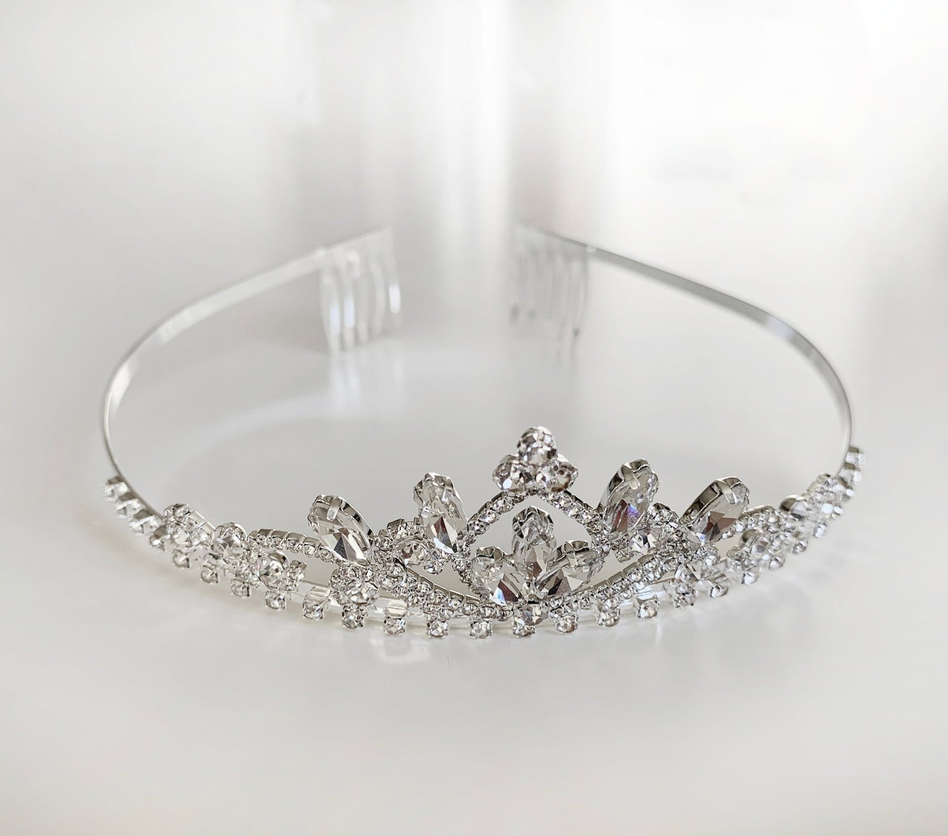 Silver tiara with crystal embellishments on a white background