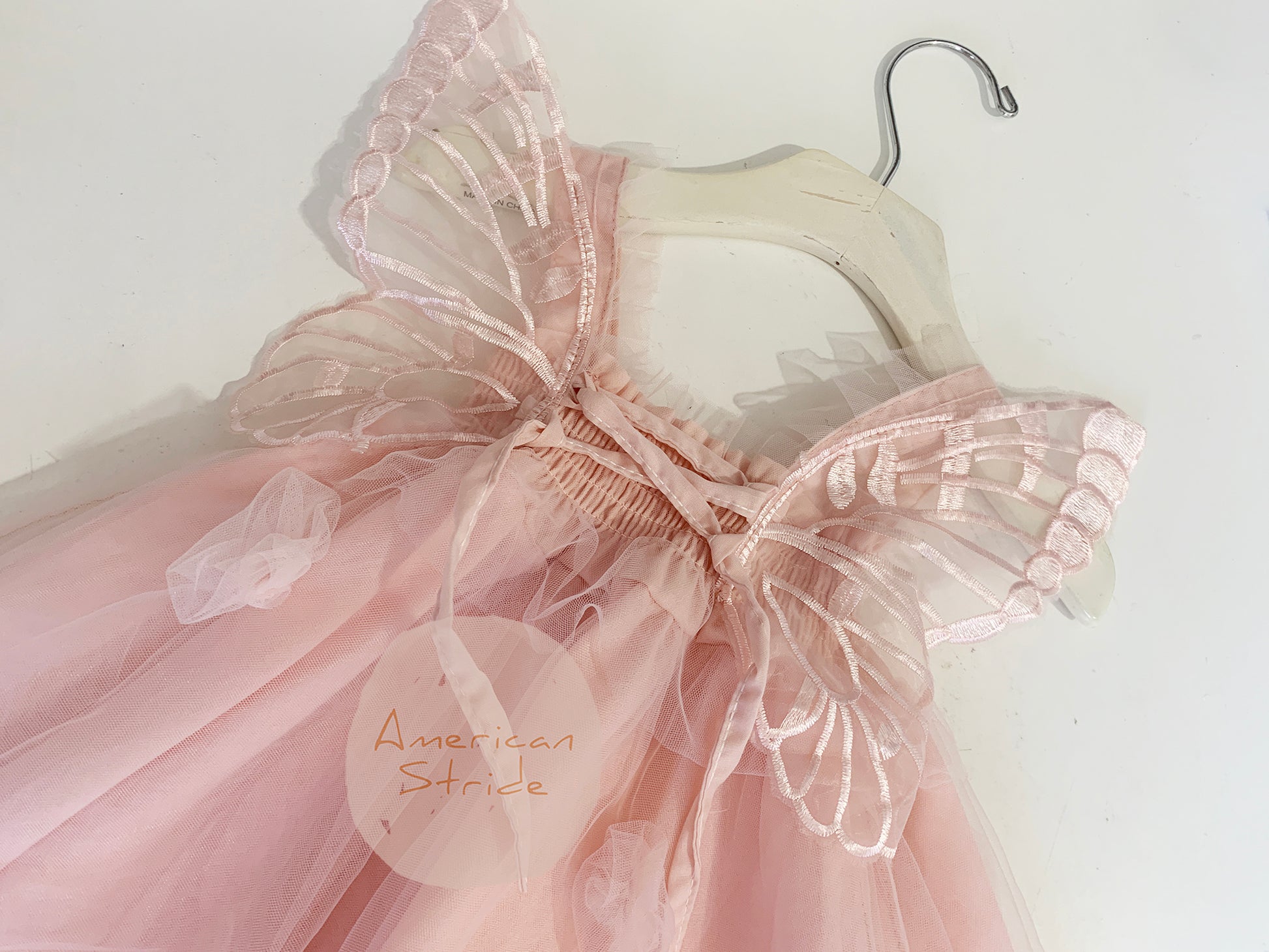 Baby Blush Butterfly Wings Lace Tulle Dress | Baby Special Occasion Dress I Flower Girl Dress - zoomed in back view on hanger