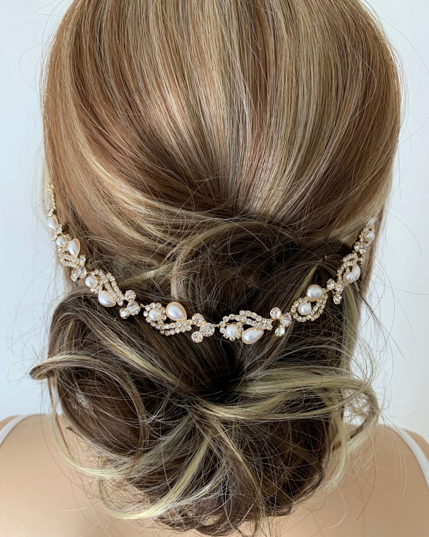 Hairpiece with pearls and crystals on a white background