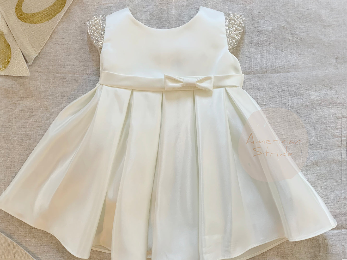 Ivory Flower Girl Beaded Short Sleeves Dull Satin dress with Detachable Pearl Sash - dress layed out front view