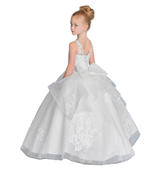 Young girl wearing a white floral dress on a white background
