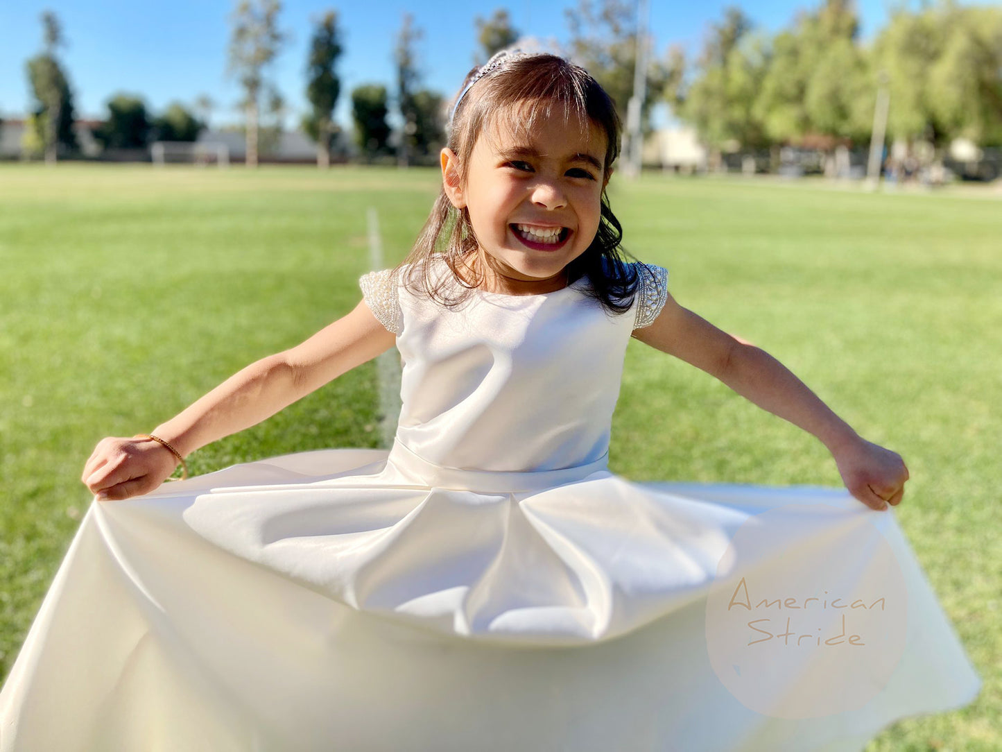 Ivory Flower Girl Beaded Short Sleeves Dull Satin dress with Detachable Pearl Sash - view of girl wearing dress with big smile and hands on skirt