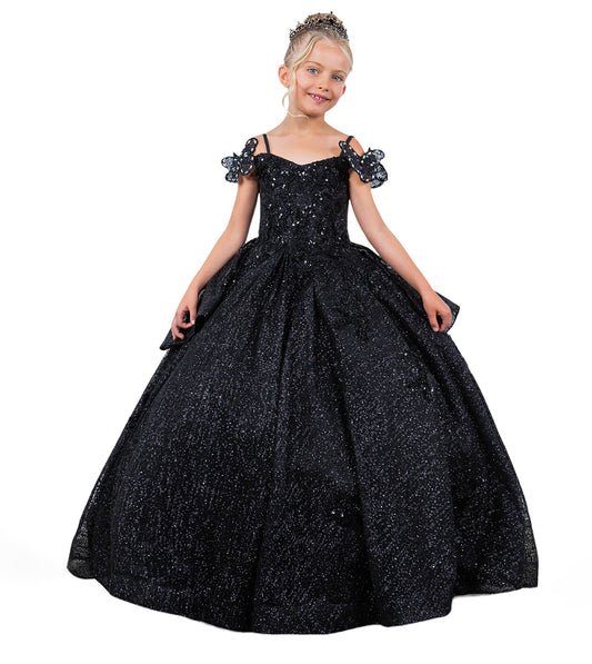 Young girl wearing a black sparkly ball gown on a white background