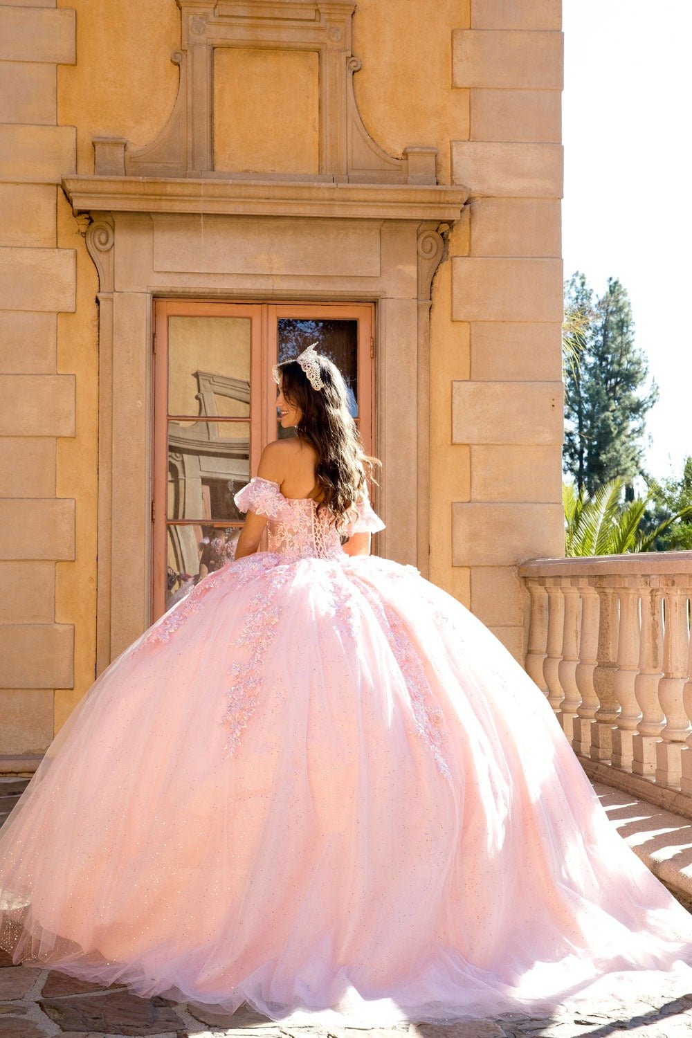blush quinceaneraball gown with  puff sleeves and a sheer embroidered bodice lace up back and long train
