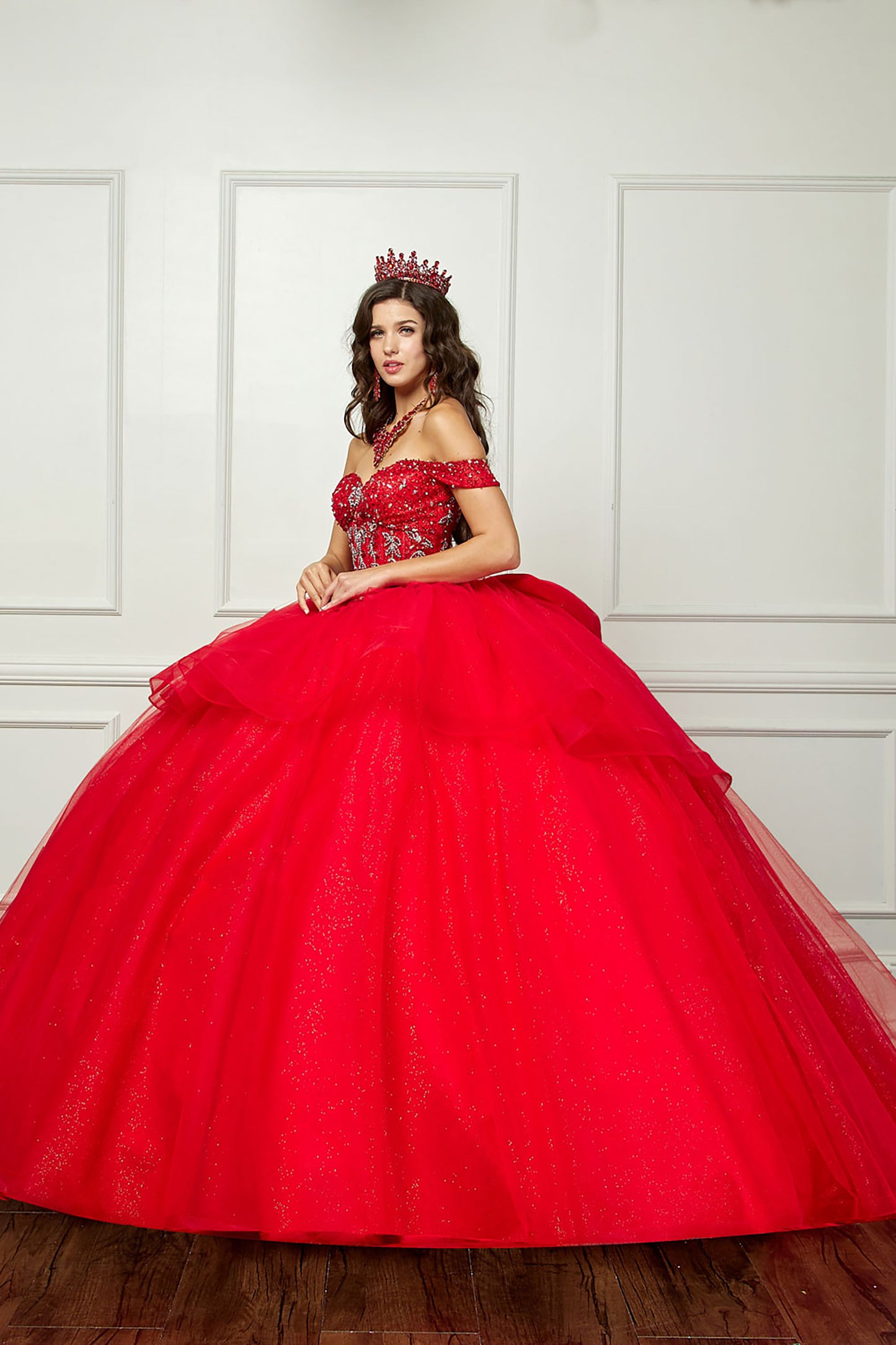 Red Quinceañera | Glittering Tulle Layers, Off-shoulder Bodice adornments, and a detachable bow | 3 Colors Available - side view of woman wearing dress and red crown