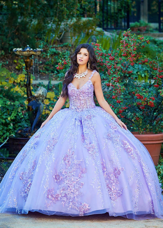Detailed view highlights a lilac quinceañera ball gown with floral applique, rhinestones, sequins and detachable sleeves.