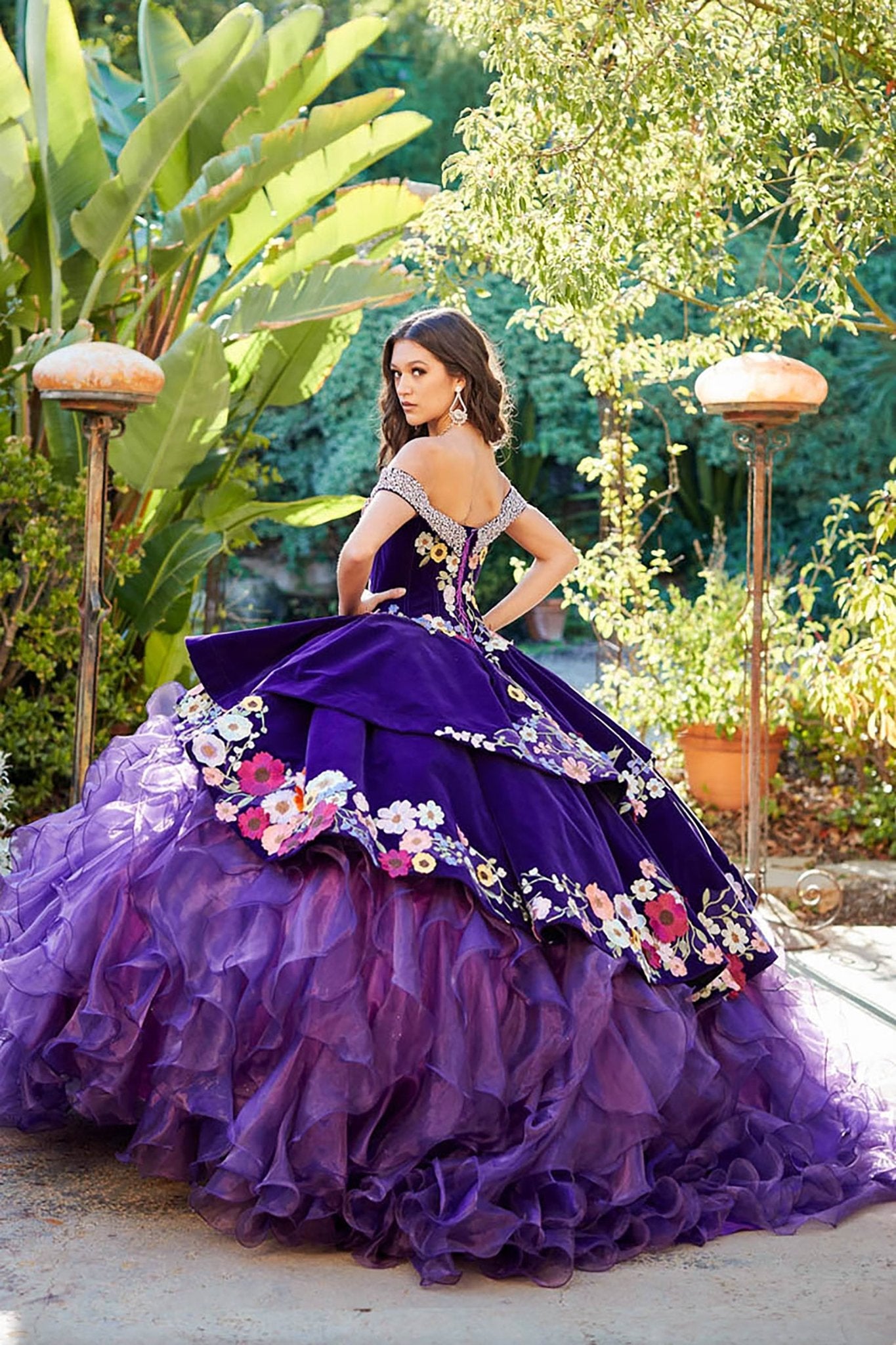 Quinceañera | Purple Charro Multi Colored Gem detail Floral Velvet with Organza Ruffled overlays Ballgown | Ainara dress back side with earring