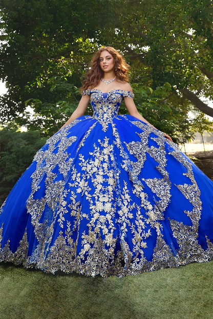 Woman wearing a sweet heart off the shoulder royal blue quinceanera ball gown with silver embroidery 