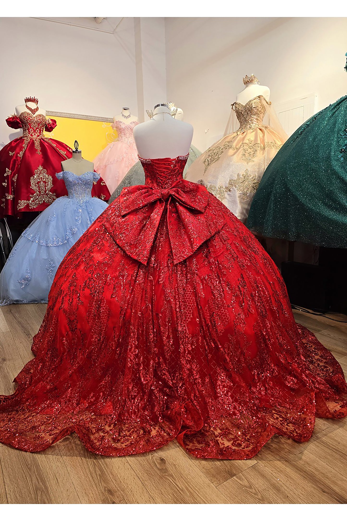 Red Quinceanera | Spackly Sequins and Embellishments See-through Corset Bodice adorned with Shimmering Gems Quince Ballgown - back view of dress and bow