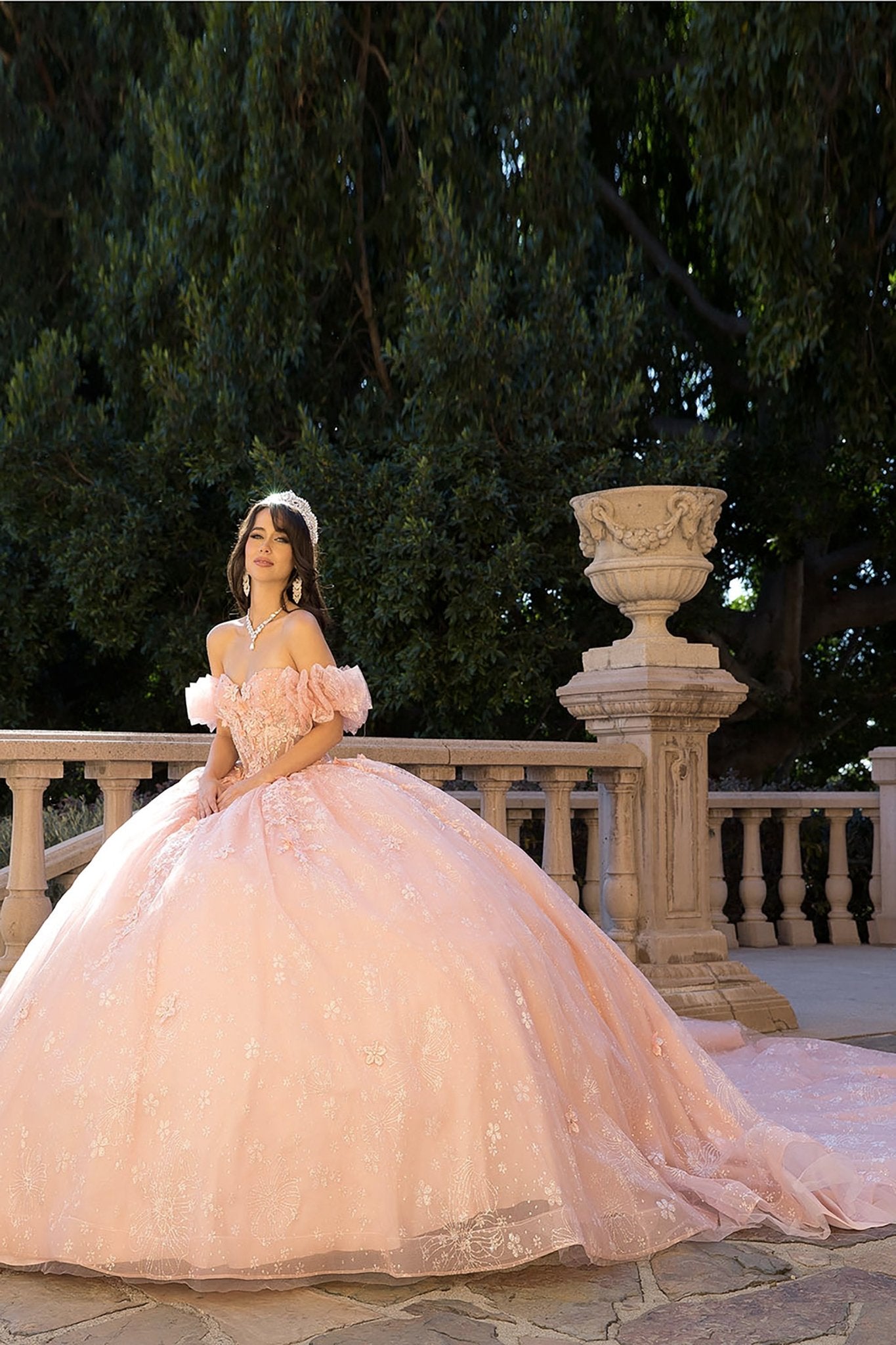 Quinceañera | Blush Long Train Ballgown with 3D Flowers, Rhinestones, and Embroidered Details with Detachable Ruffle Sleeves | Analia dress side