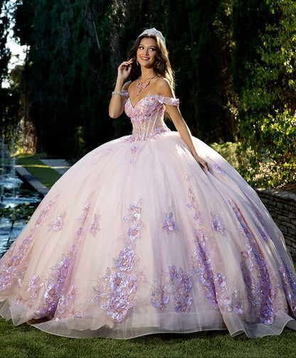 Girl in a pink and lilac floral gown standing outdoors with trees in the background