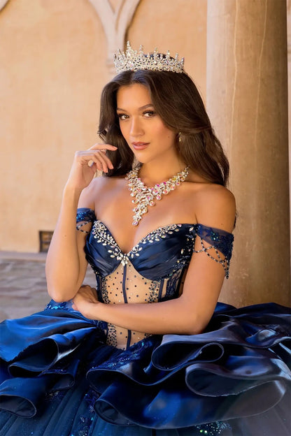 close up a girl in a navy quinceanera ball gown with rhinestone on the top