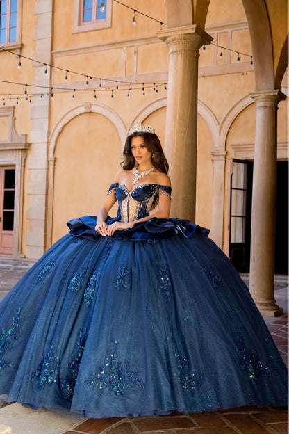 Woman in a navy quinceanera ball gown with ruffled overlays 