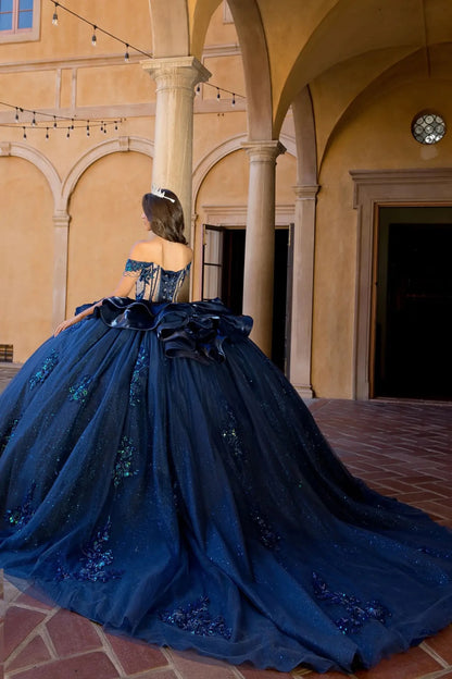 Woman in a navy quince ball gown showing extra long back train