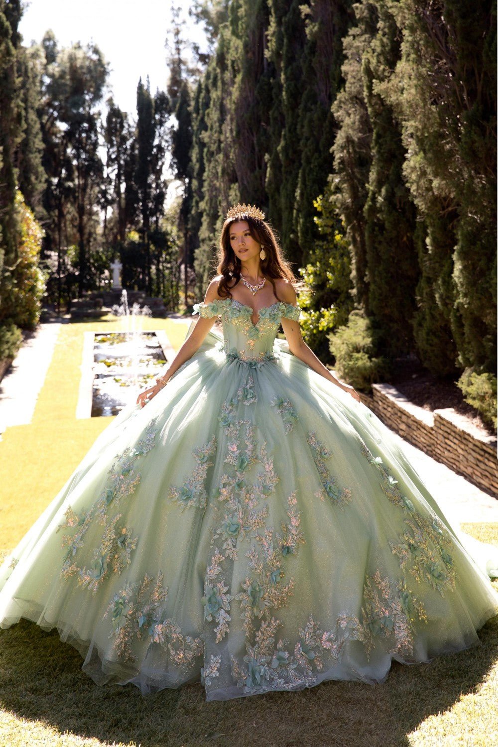 Woman in a sage floral quince dress standing in a garden