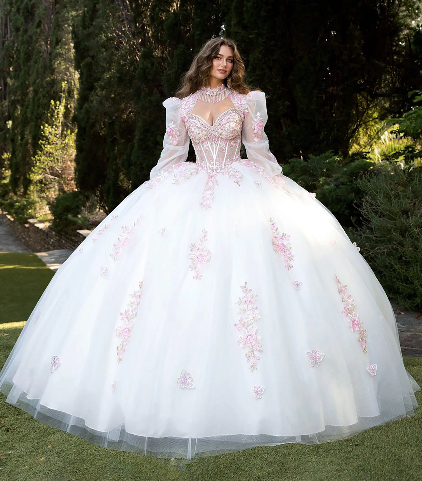 Front view of a woman wearing a white quinceañera dress with floral details, corset bodice and layered skirt