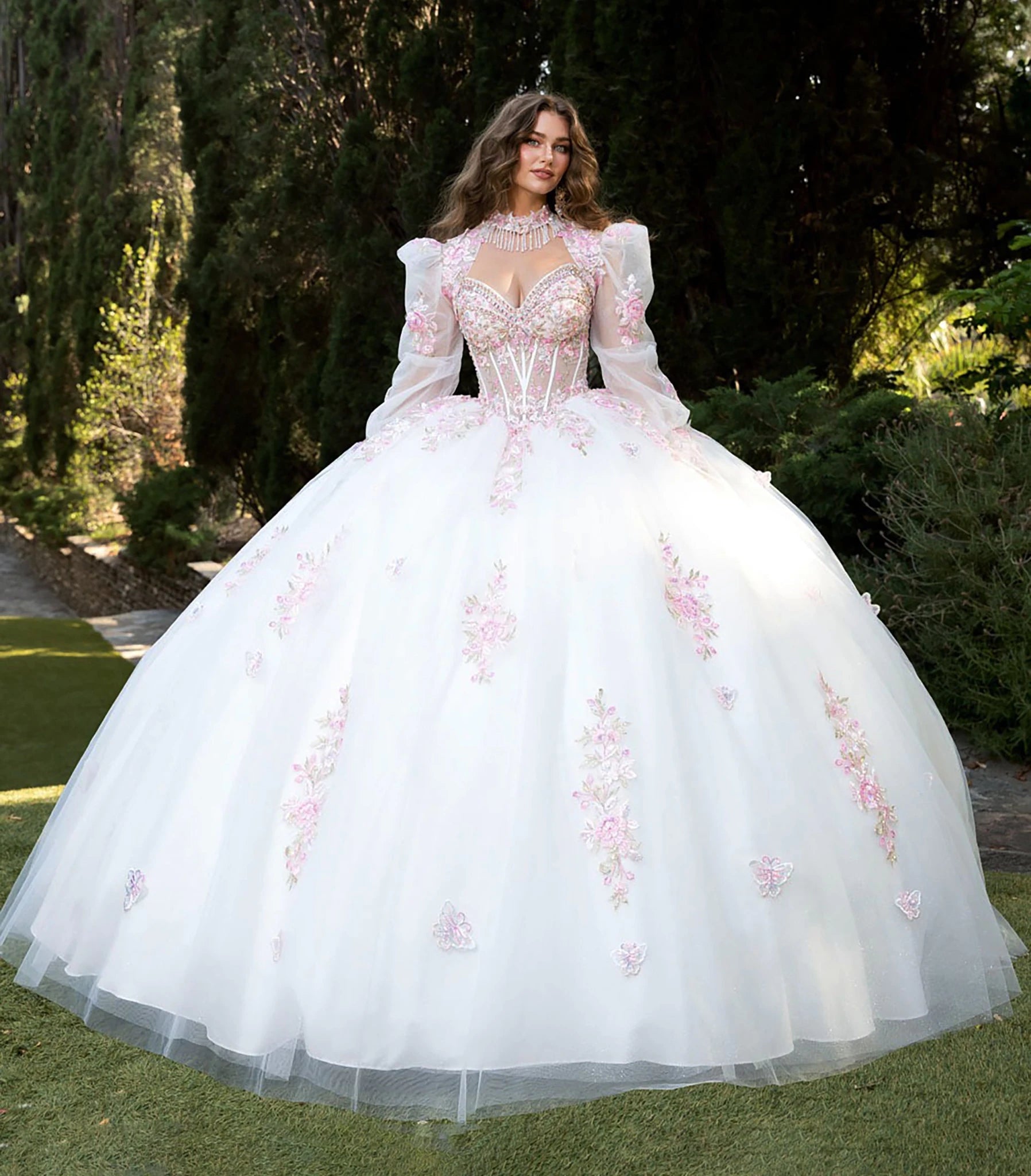 Front view of a woman wearing a white quinceañera dress with floral details, corset bodice and layered skirt
