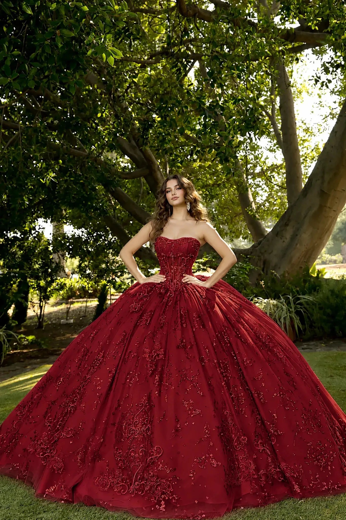 Front view of a sleeveless red quinceañera dress with lace-up corset, embroidered bodice and glitter tulle skirt