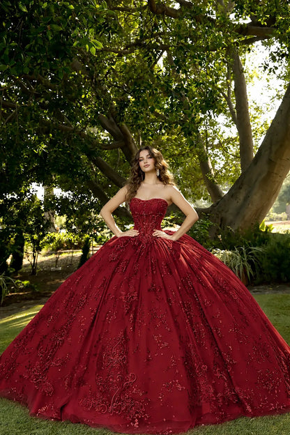 Front view of a sleeveless red quinceañera dress with lace-up corset, embroidered bodice and glitter tulle skirt