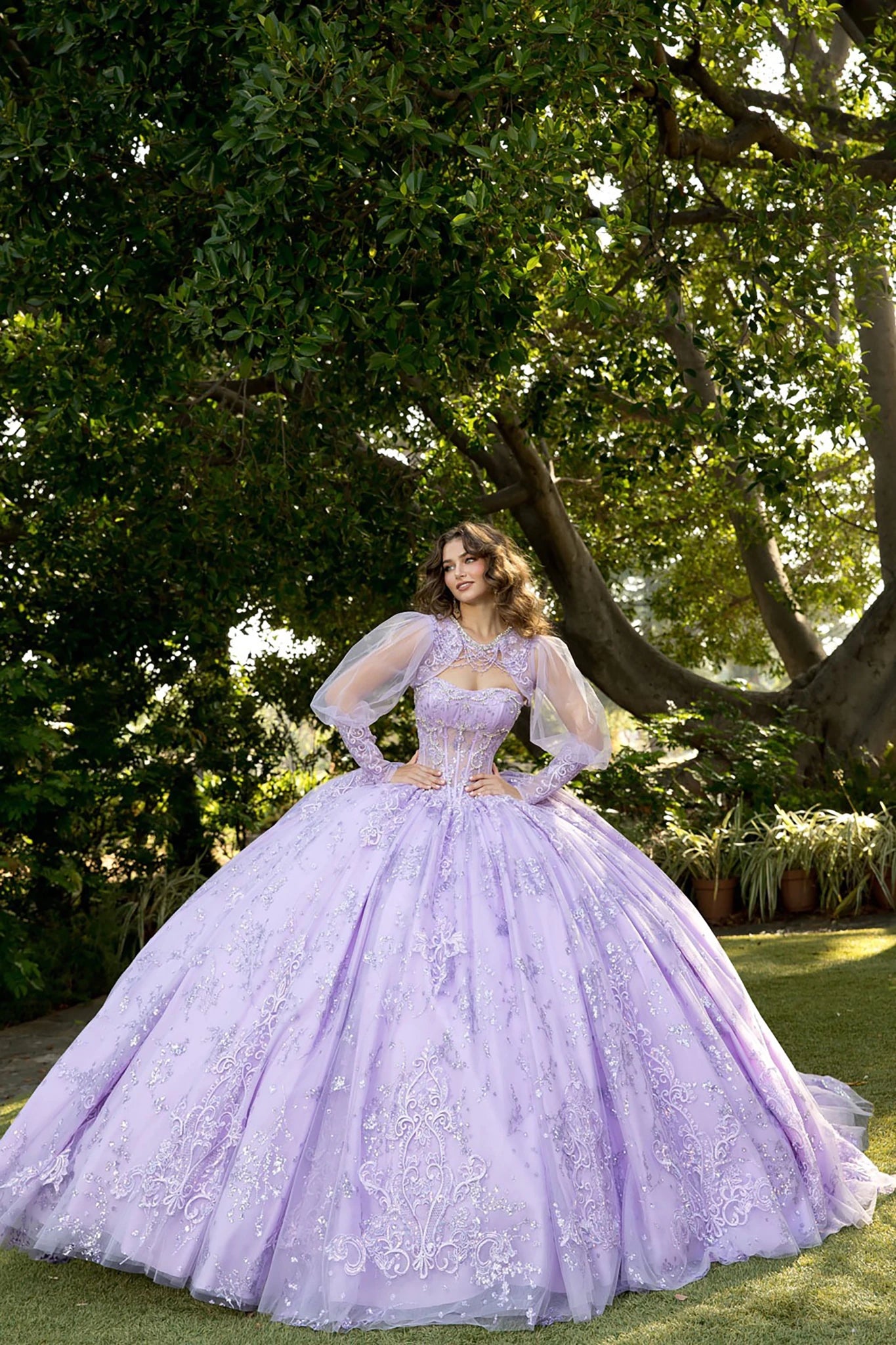 Front view of a woman wearing a lavender quinceañera dress with corset bodice and layered skirt