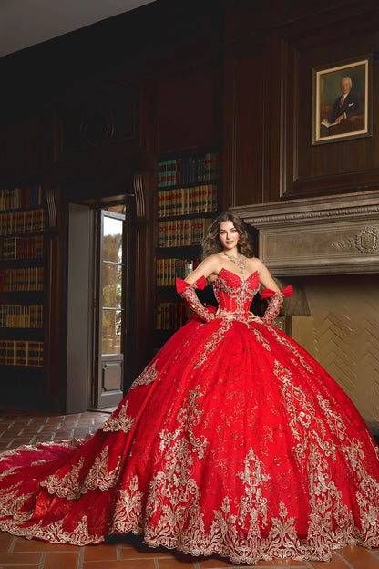 Front view of a woman wearing a red quinceañera dress with gold embroidery, ornate detailing and corset bodice