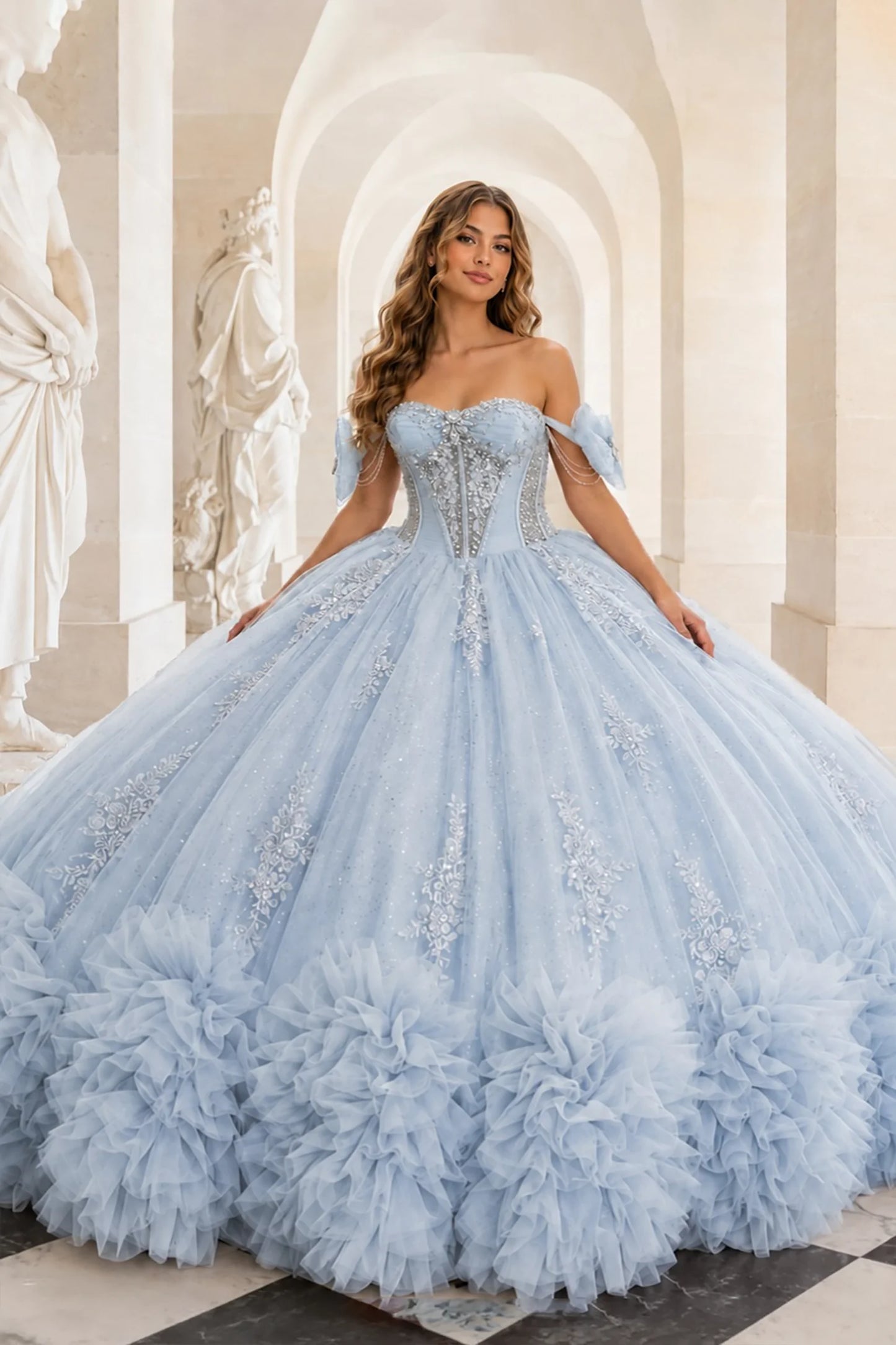 Light blue quinceañera ball gown with embellished sweetheart strapless corset, floral appliqués, pearls, sequins and ruffled hem 