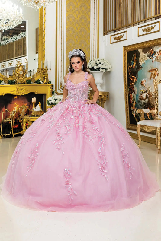 Woman standing front-facing in pink quinceañera ball gown with deep V-neckline, embroidered floral details, sheer overlay, and voluminous layered skirt