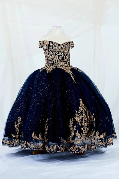 Navy blue kid ball gown dress with gold embroidery and shiny tulle on a mannequin against a white background