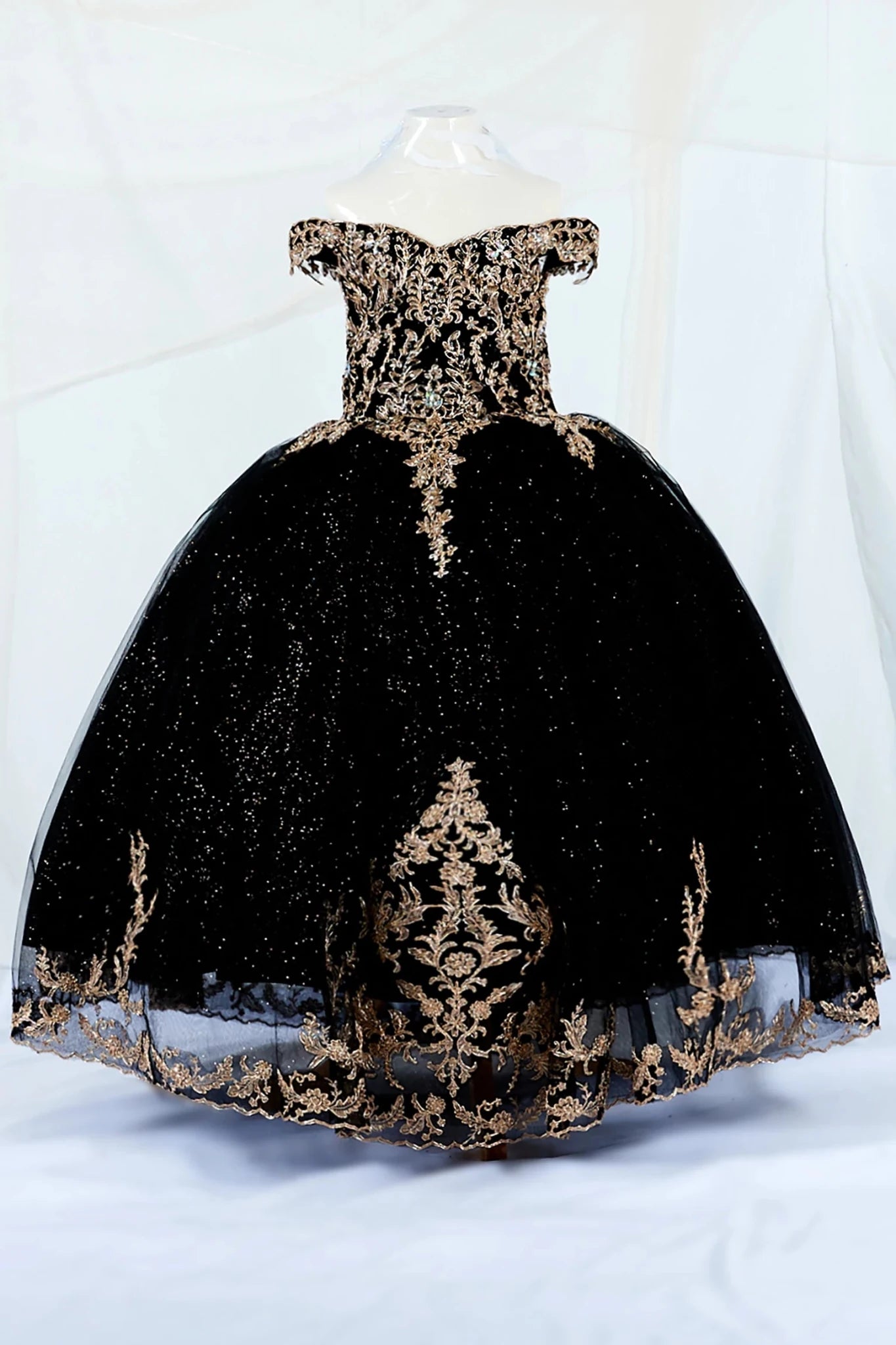 Black kid ball gown mini quince dress with gold embroidery and shiny tulle on a white background