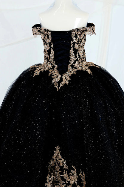 Black shiny tulle mini quince ball gown with gold embroidery showing the back of the dress, lace up back