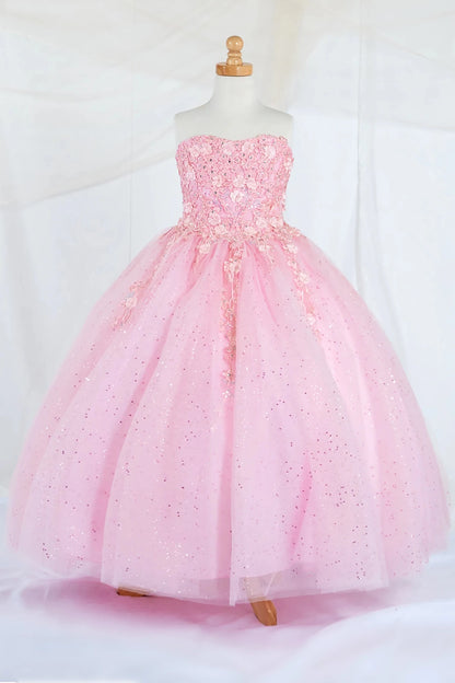 Front-facing display of a bubble-pink ball gown featuring a strapless 3D floral appliqué bodice and a full glitter tulle layered skirt.