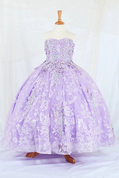 Front-facing display of a lilac ball gown featuring a 3D floral appliqué bodice with butterfly accents and a glitter tulle layered skirt.