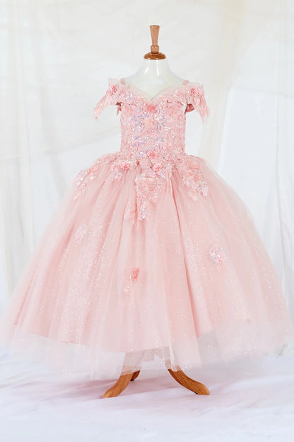 Front-facing display of an elegant blush ball gown featuring a fitted bodice, detachable bow accent, and a glitter tulle layered skirt.