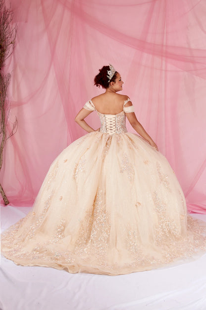 Back-Facing of a woman wearing Champagne formal gown featuring bow detail trailing skirt and soft silhouette