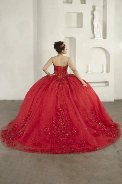 Back-Facing of a woman wearing Red formal gown featuring fitted bodice full skirt and flowing silhouette